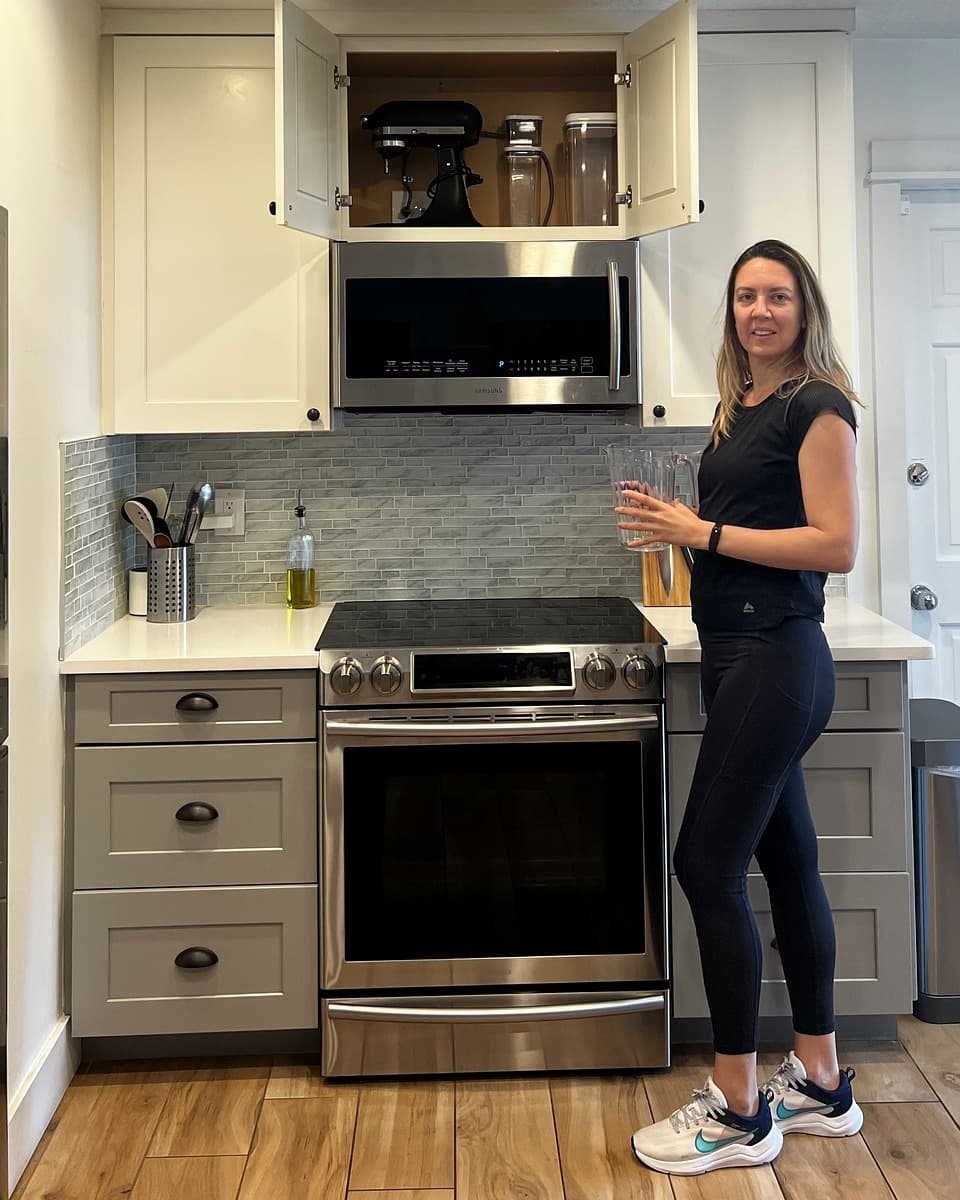 Professional organizer Priscila organizing a client's kitchen cabinet