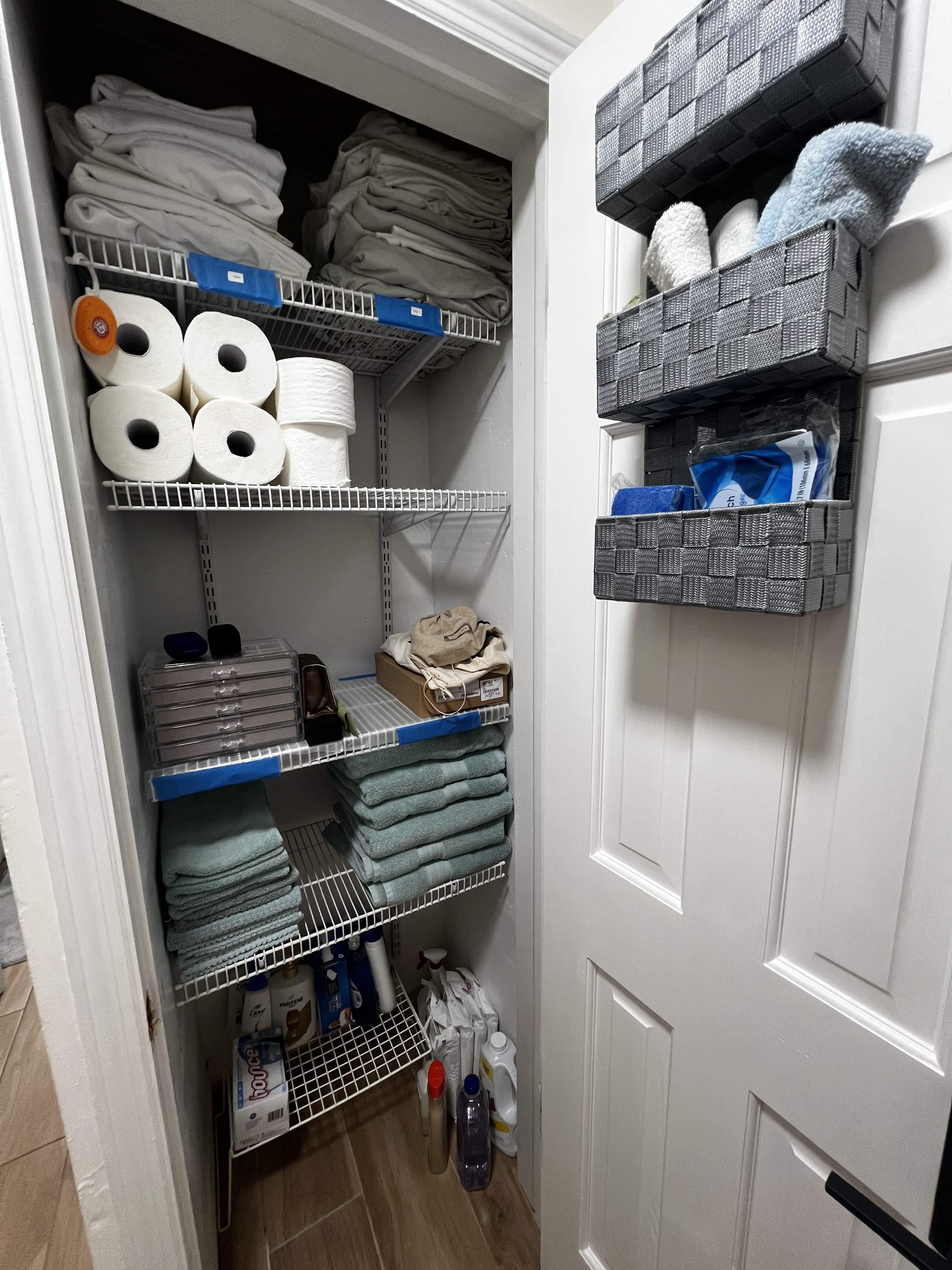 Neatly folded linens on labeled closet shelves